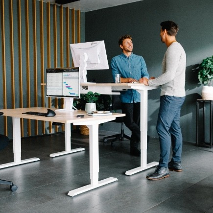 Moderne Büroplanung mit höhenverstellbaren Schreibtischen im Arbeitseinsatz